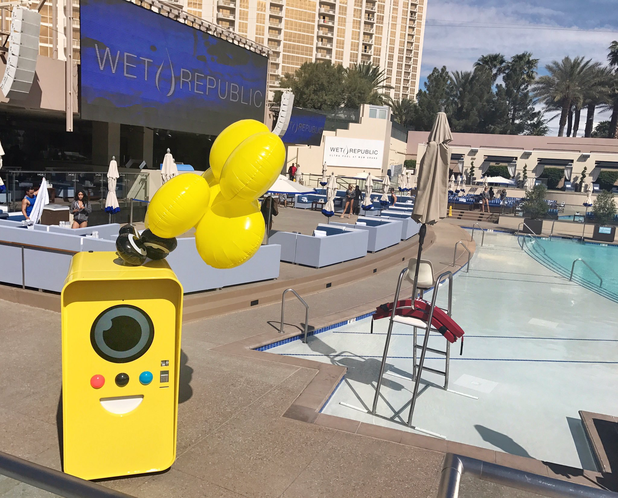 Yellow Snapbot vending machine with balloons beside the pool at Wet Republic, MGM Grand, Las Vegas